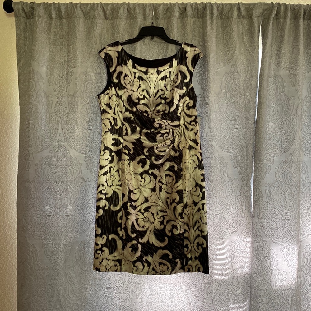 A knee length black design satin zip up dress